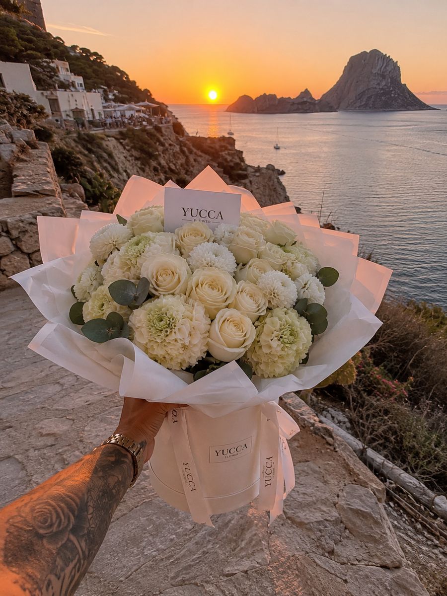 Sunset bouquet in Ibiza — YUCCA Flowers floristry Bouquet of peonies and palm leaves against a Mediterranean sunset over the sea near Café del Mar in Ibiza